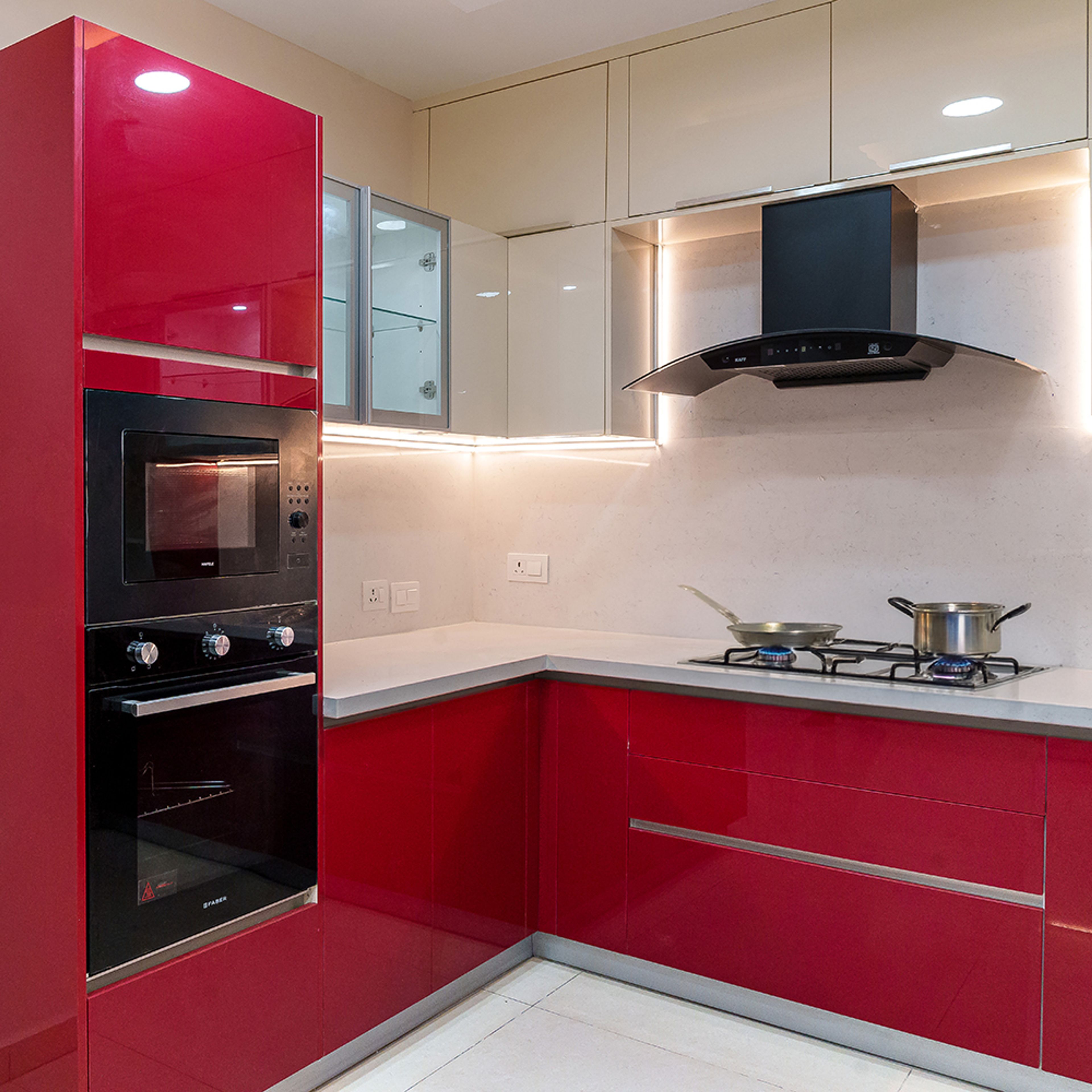 Modern dual tone kitchen with high gloss red and beige laminate, white quartz countertop, and built-in appliances in Bengaluru | Material Depot