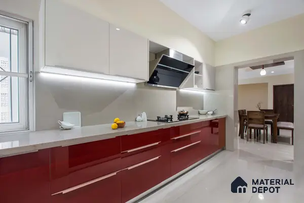 Modern dual tone kitchen with high gloss red and frosty white laminate, quartz countertop, and beige floor tile in Bengaluru | Material Depot
