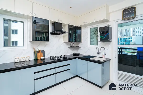 Modern dual tone kitchen with pastel blue and frosty white high gloss laminate, black quartz countertop, and marble-look backsplash tile in Bengaluru | Material Depot