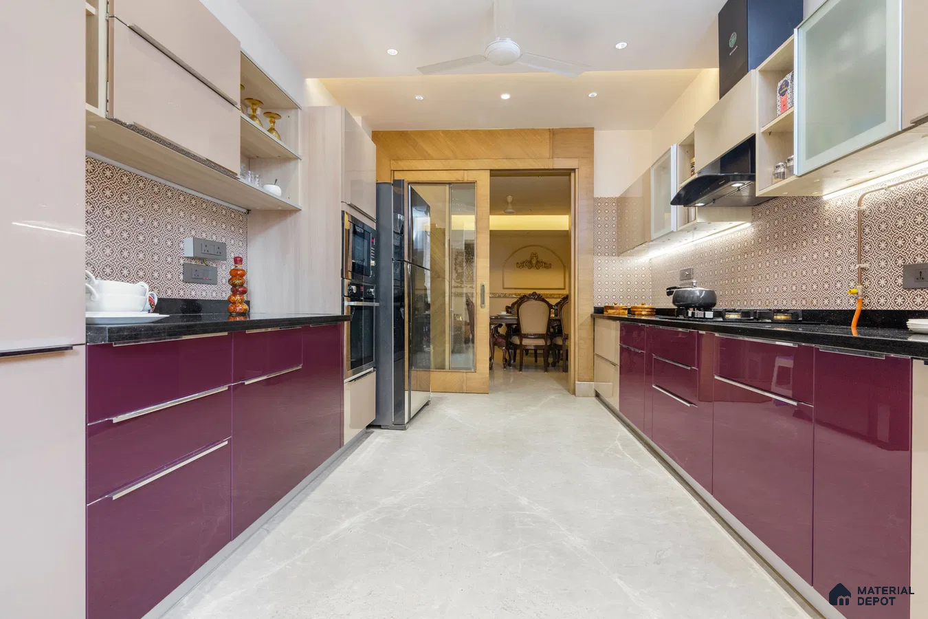 Modern dual tone kitchen with plum high gloss laminate, beige laminate, black granite countertop, and patterned backsplash tiles in Bengaluru | Material Depot