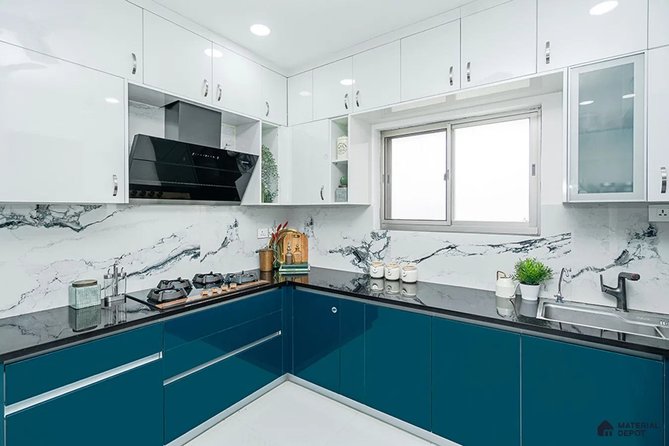 Modern dual tone kitchen with teal blue and frosty white high gloss laminate, marble-look backsplash tile, and black granite countertop in Bengaluru | Material Depot