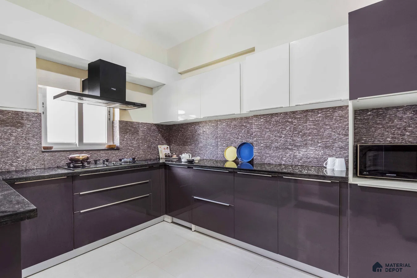 Modern dual tone kitchen with white and deep plum laminate, textured brown backsplash tile, and black granite countertop in Bengaluru | Material Depot