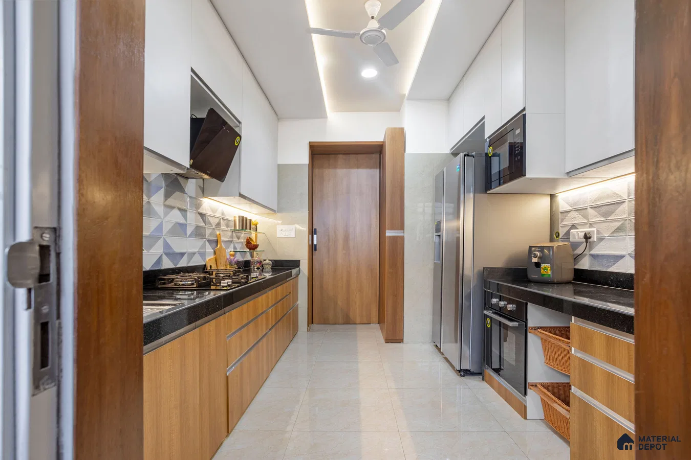 Modern dual tone kitchen with white and wood grain laminate, black granite countertop, and geometric 3D backsplash tiles in Bengaluru | Material Depot
