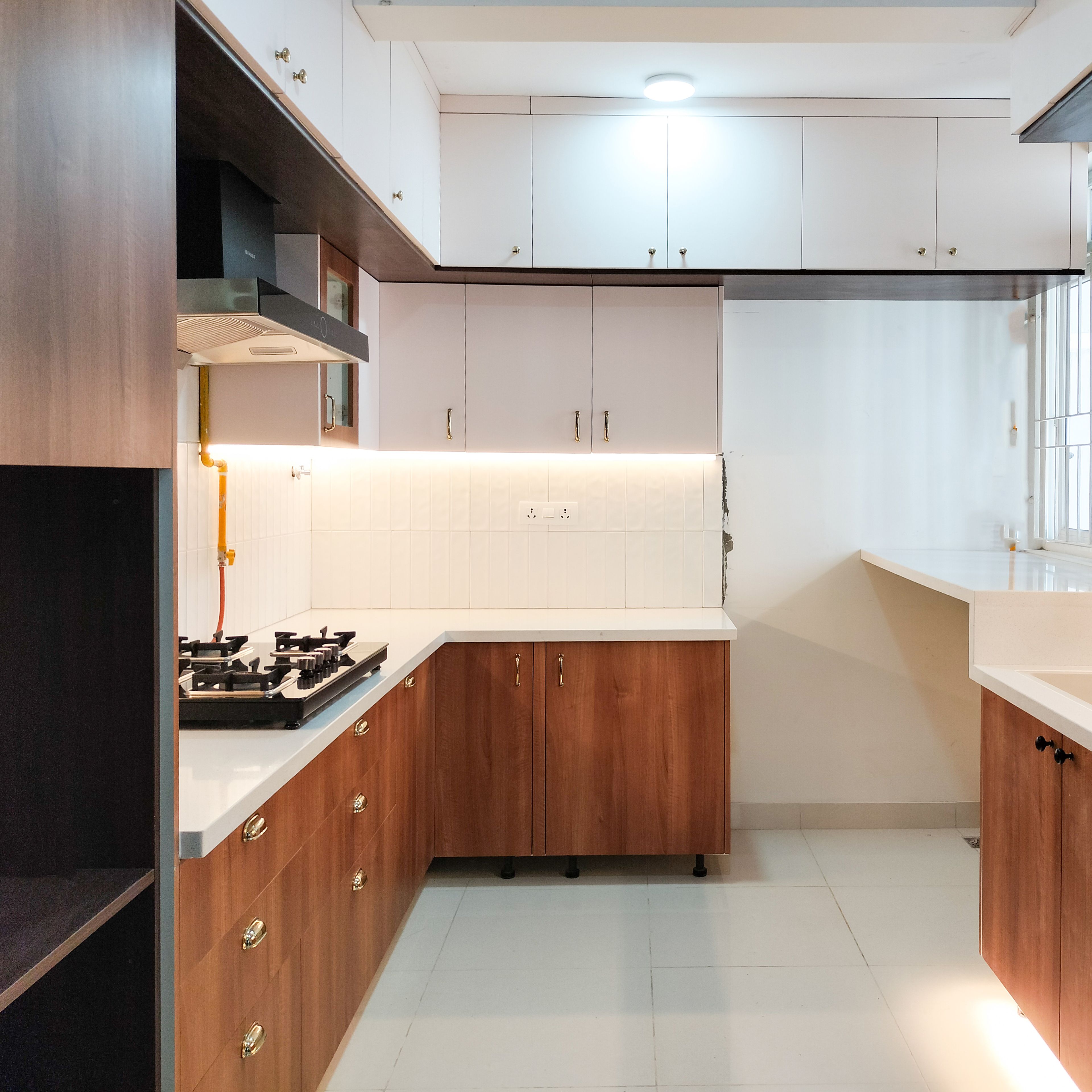 Modern dual tone kitchen with white solid laminate, walnut brown wood laminate, and white quartz countertop in Bengaluru | Material Depot