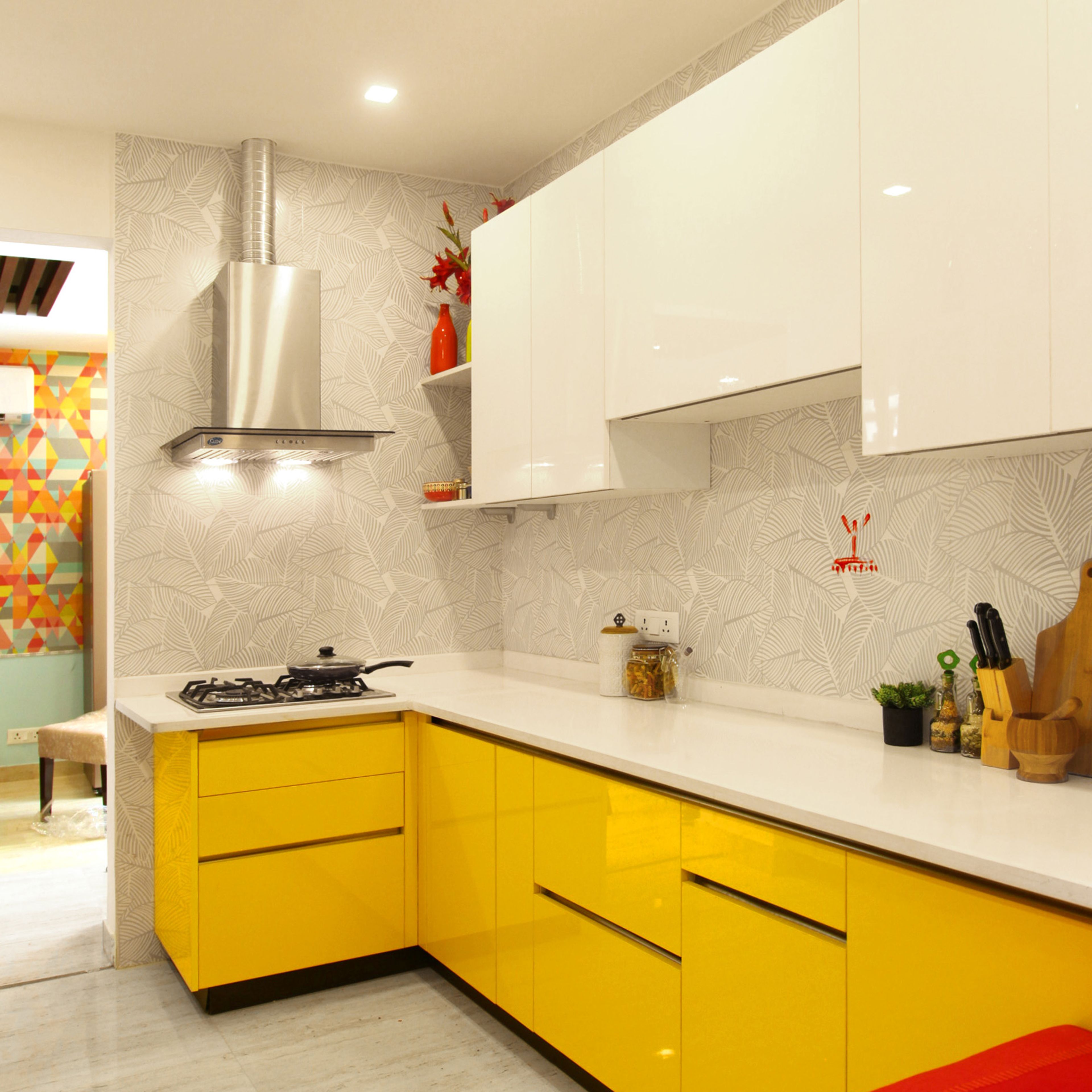 Modern dual tone kitchen with yellow high gloss laminate, white high gloss laminate, and white quartz countertop in Bengaluru | Material Depot