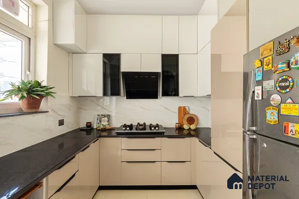 Modern kitchen with beige and frosty white high gloss laminate, black granite countertop, and marble-look backsplash in Bengaluru | Material Depot
