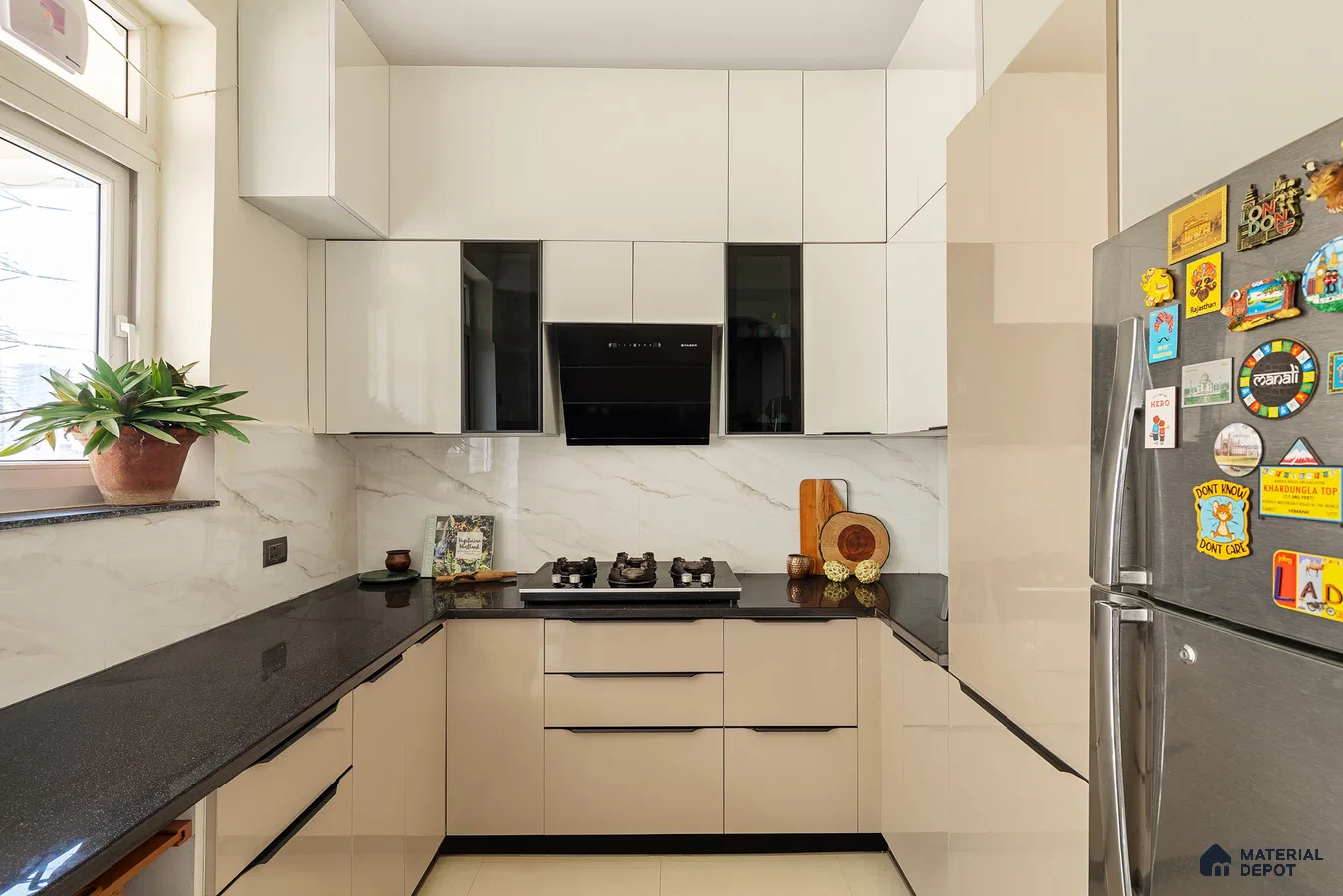Modern kitchen with beige and frosty white high gloss laminate, black granite countertop, and marble-look backsplash in Bengaluru | Material Depot