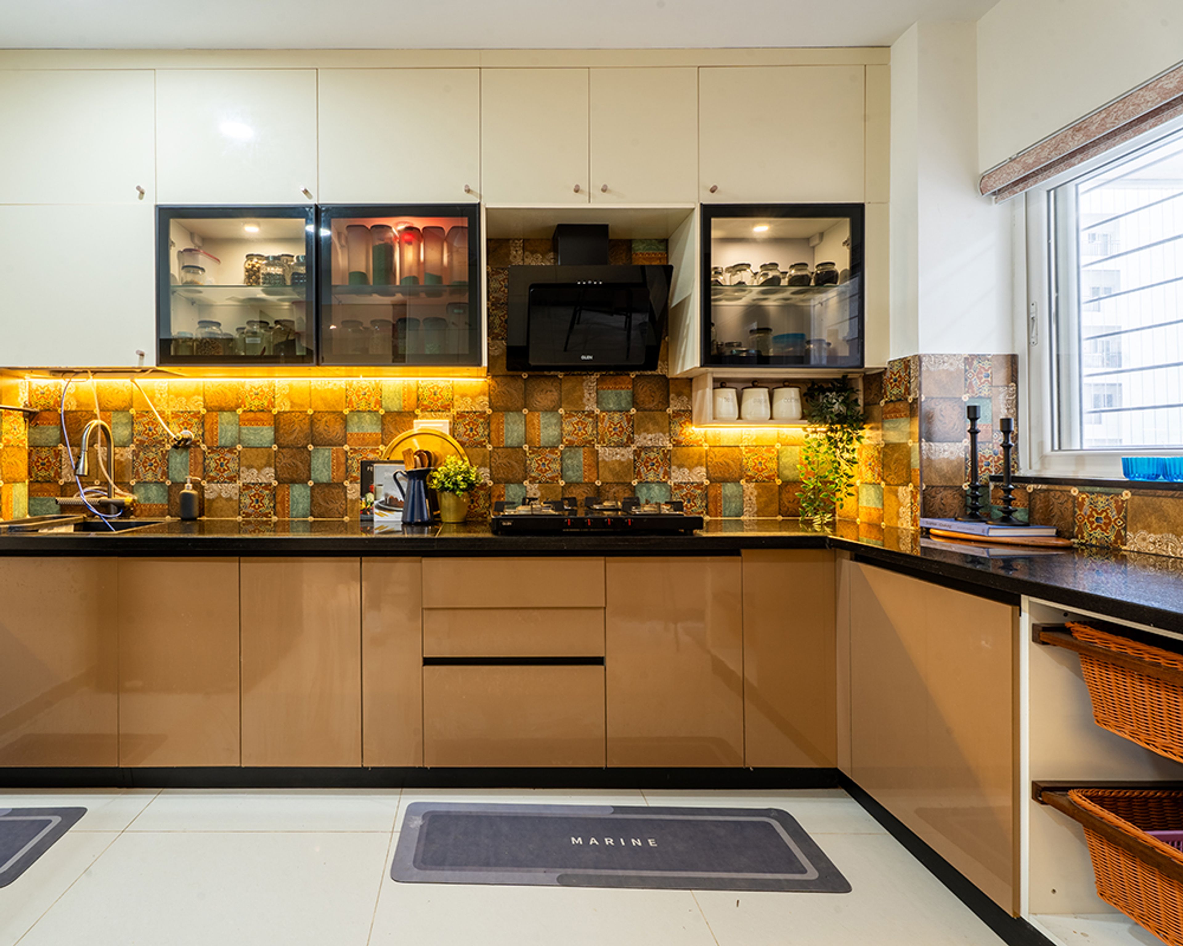 Modern kitchen with beige high gloss laminate, patterned moroccan backsplash tiles, and black granite countertop in Bengaluru | Material Depot