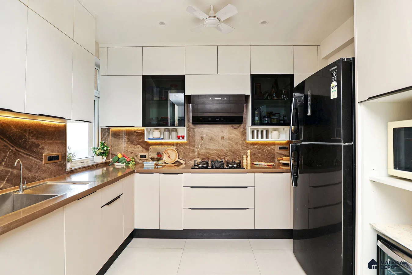 Modern kitchen with beige laminate cabinets, brown marble backsplash, and brown quartz countertop in Bengaluru | Material Depot