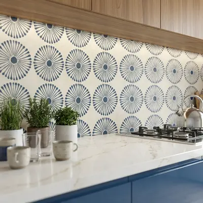 Modern kitchen with blue geometric patterned backsplash tile, white marble-look quartz countertop, and walnut wood laminate cabinets