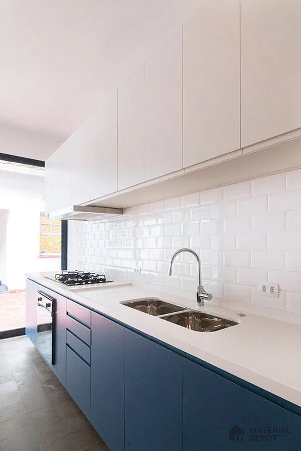 Modern kitchen with blue laminate base cabinets, white laminate wall cabinets, and white subway tile backsplash in Bengaluru | Material Depot