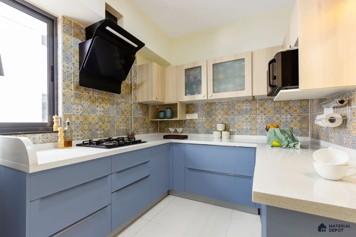 Modern kitchen with blue laminate cabinets, white quartz countertop, and yellow-blue patterned moroccan backsplash tiles in Bengaluru | Material Depot