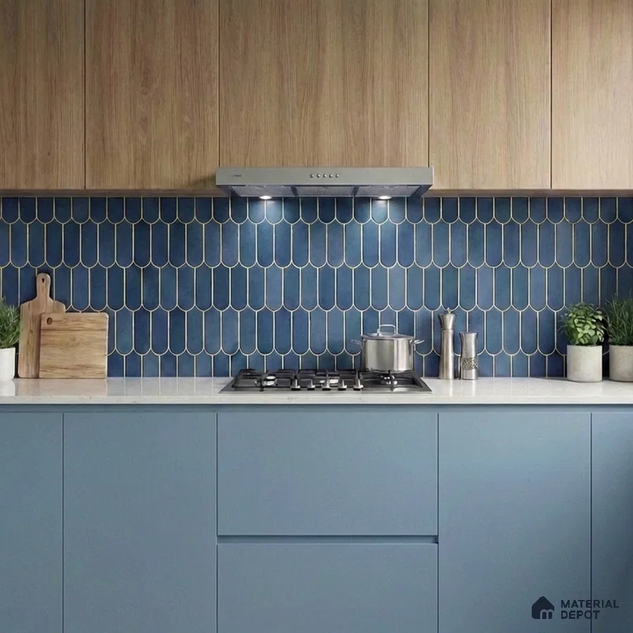 Modern kitchen with blue scallop tile backsplash, light wood laminate cabinets, and matte blue laminate base units