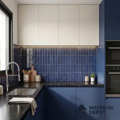 Modern kitchen with blue vertical subway backsplash tile, matte blue and white laminate cabinets, and black marble countertop