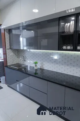 Modern kitchen with glossy grey and white laminate cabinets, black granite countertop, and 3D geometric white backsplash tile in Bengaluru | Material Depot