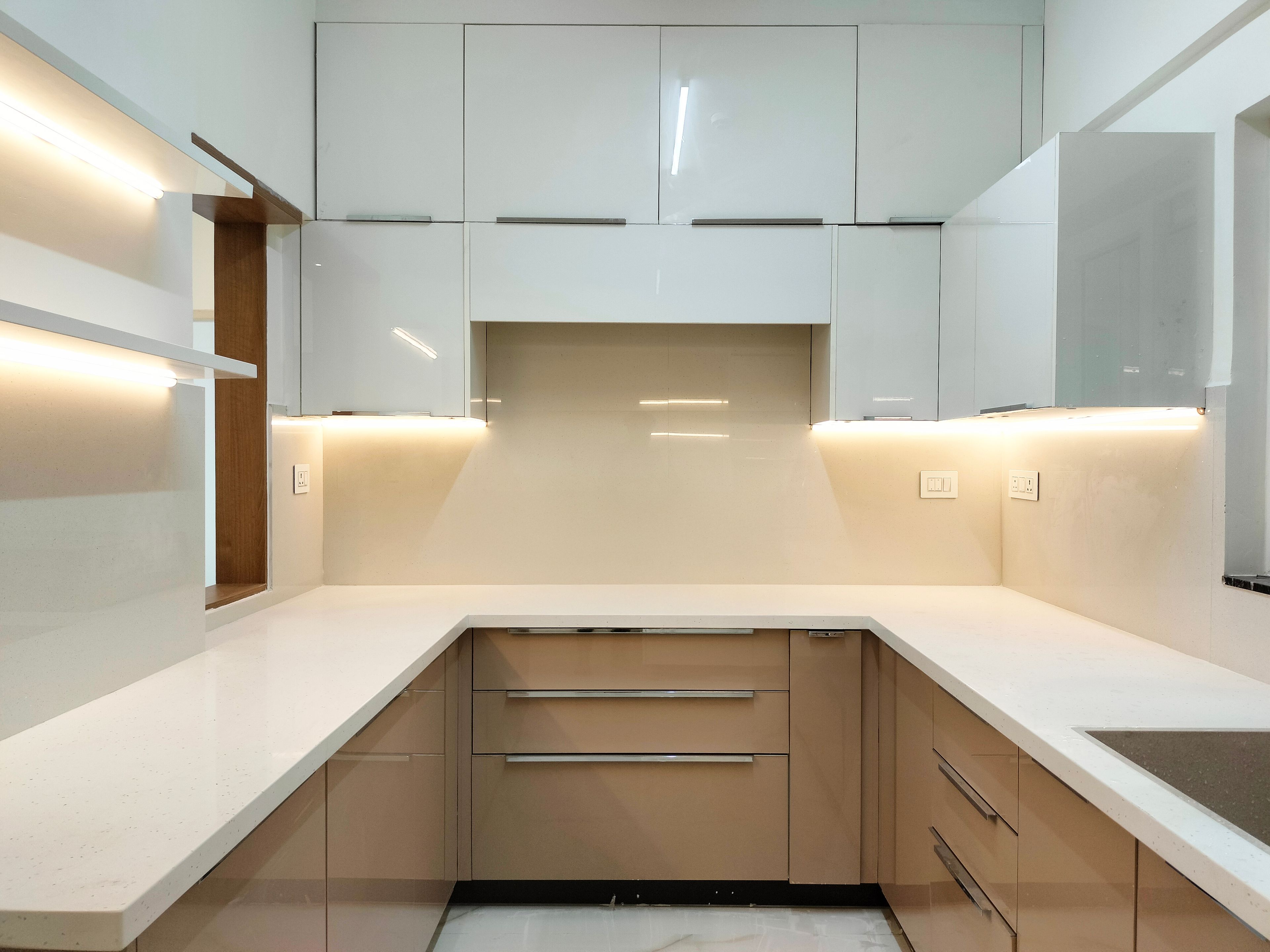 Modern kitchen with glossy white and beige laminate, white quartz countertop, and L-shaped layout in Bengaluru | Material Depot