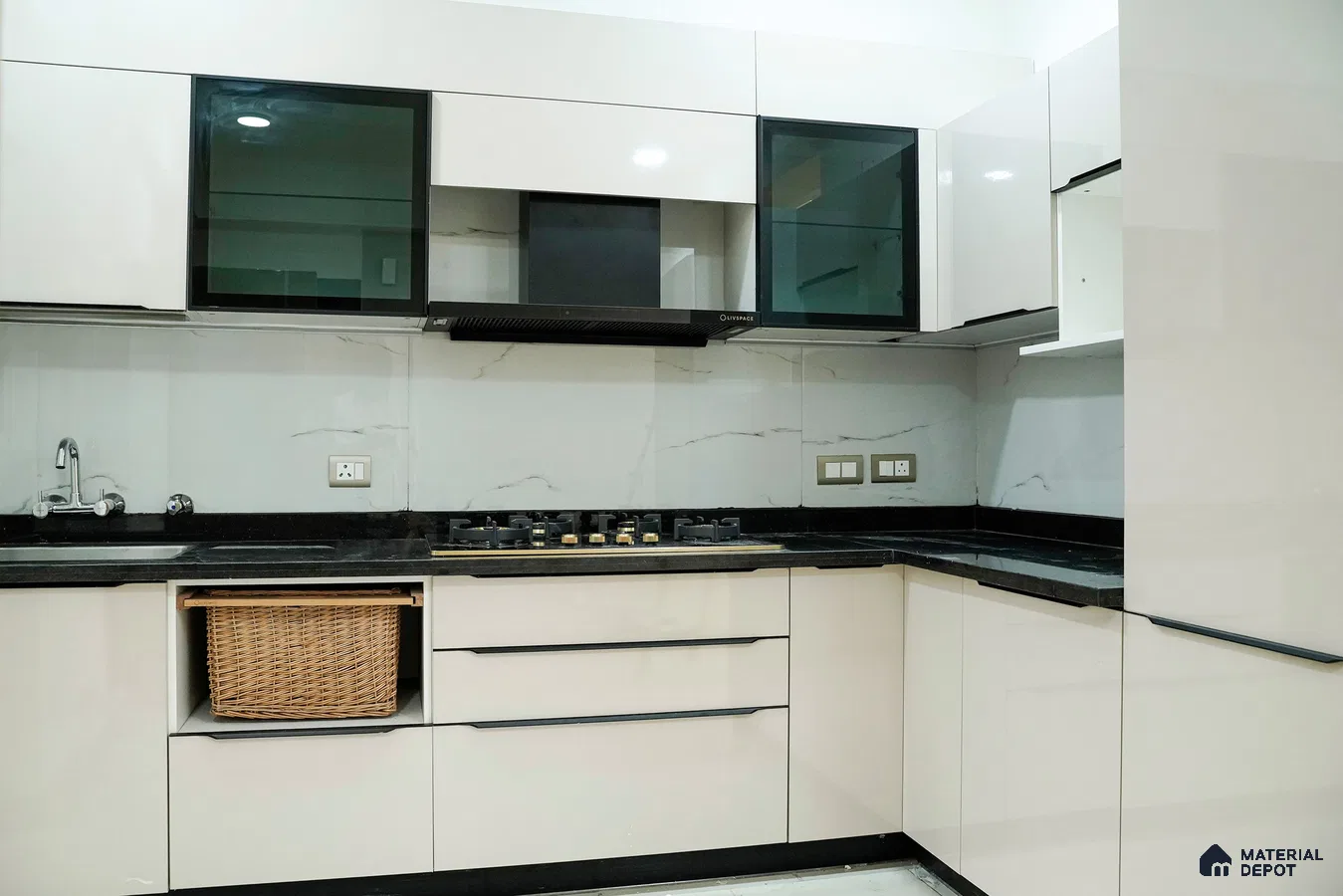 Modern kitchen with glossy white laminate cabinets, black granite countertop, and marble-look backsplash in Bengaluru | Material Depot