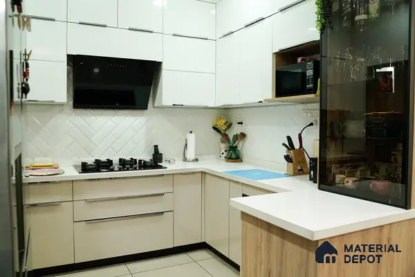 Modern kitchen with glossy white laminate cabinets, white quartz countertop, and herringbone subway backsplash tile in Bengaluru | Material Depot