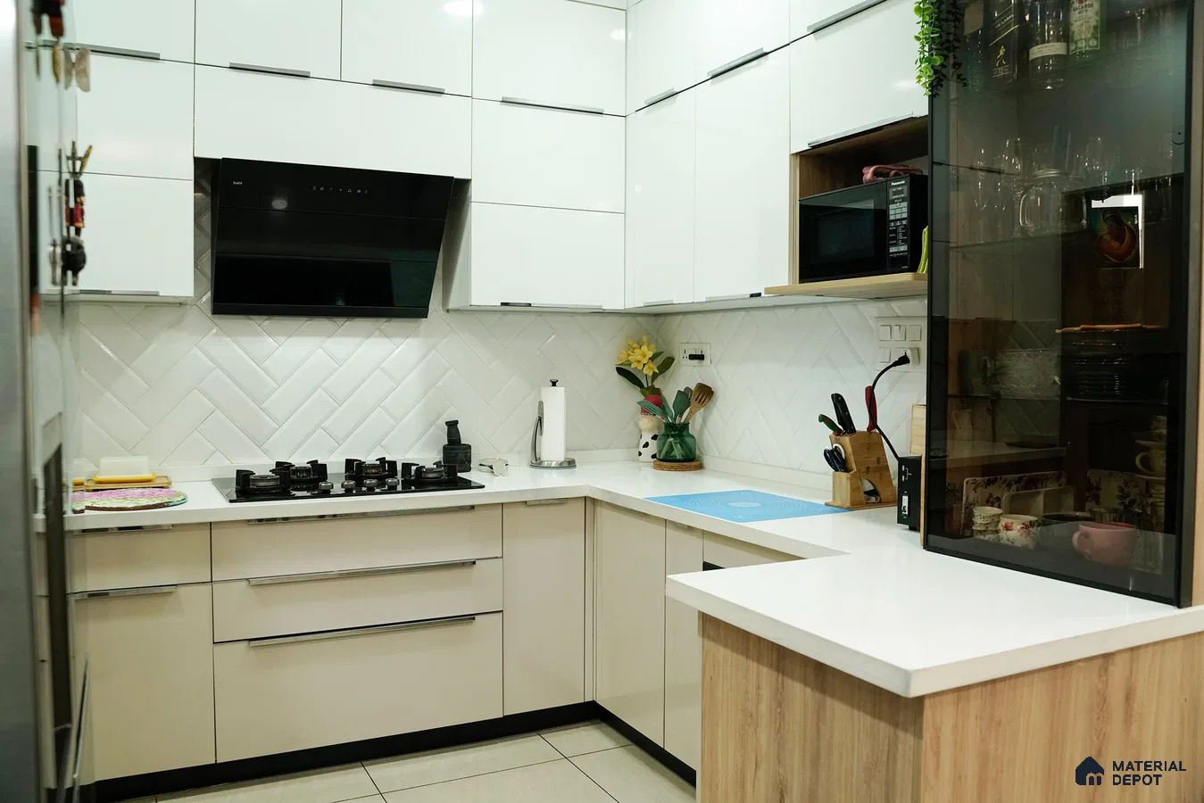 Modern kitchen with glossy white laminate cabinets, white quartz countertop, and herringbone subway backsplash tile in Bengaluru | Material Depot
