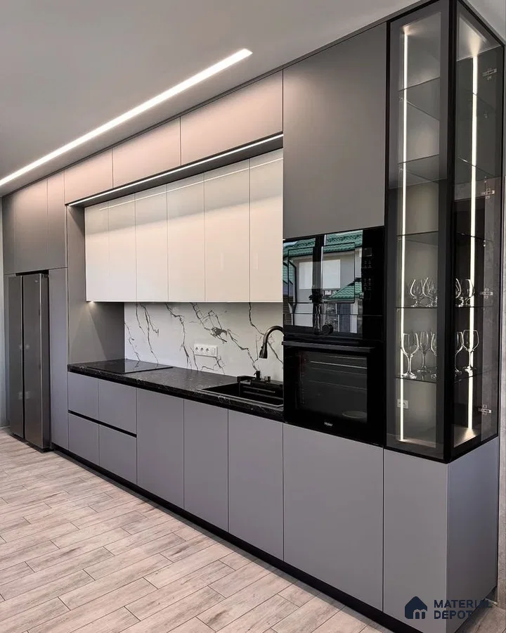 Modern kitchen with grey and white laminate cabinets, black granite countertop, and marble-look backsplash in Bengaluru | Material Depot