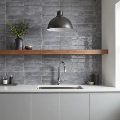 Modern kitchen with grey subway wall tiles, matte grey laminate cabinets, and white quartz countertop