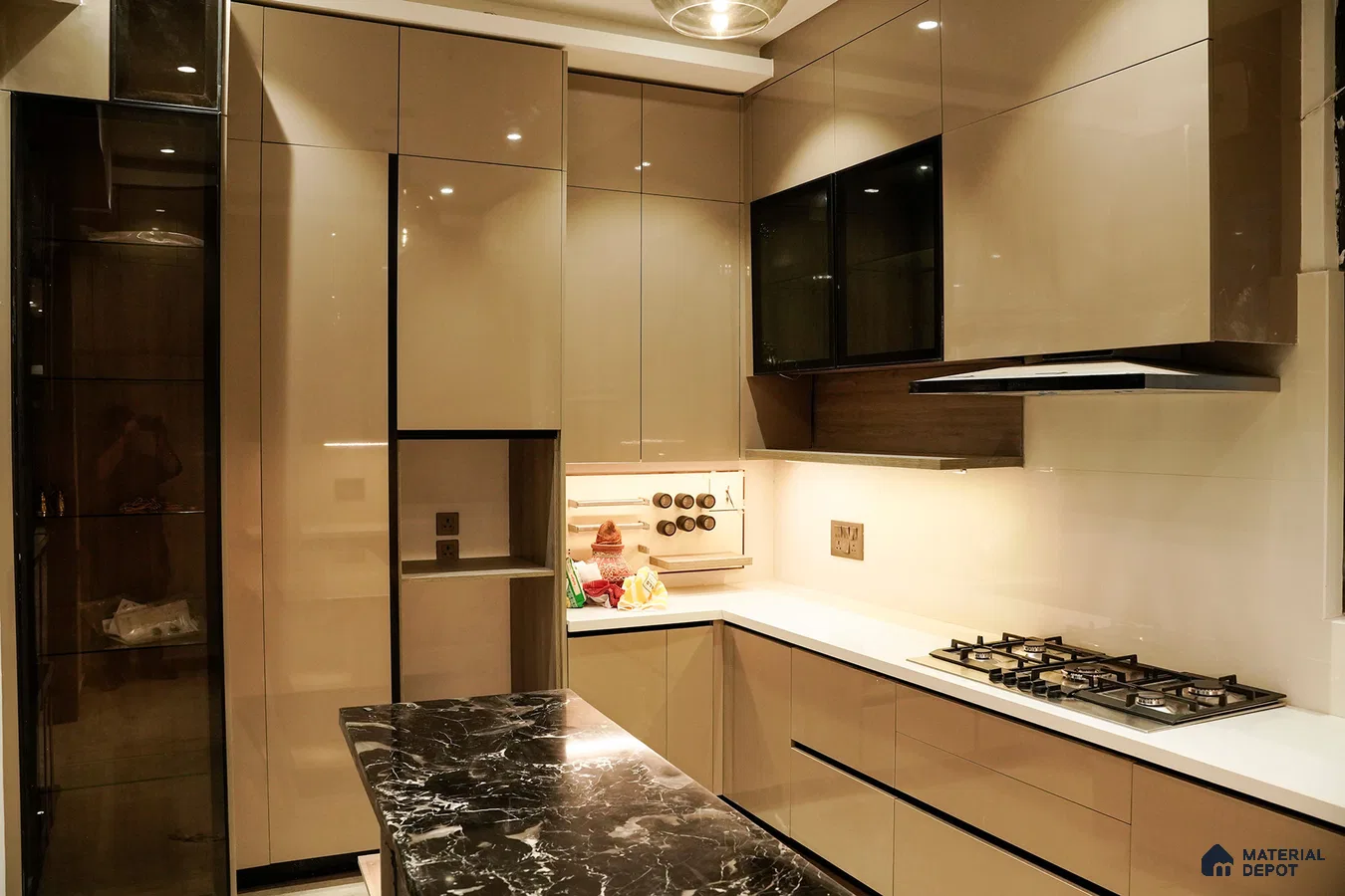 Modern kitchen with high gloss beige laminate, white quartz countertop, and black marble island in Bengaluru | Material Depot