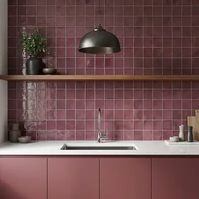 Modern kitchen with mauve square wall tiles, matte mauve laminate cabinets, and white quartz countertop