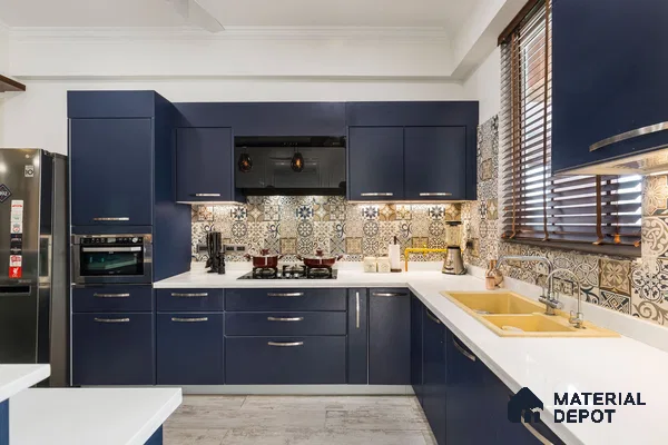 Modern kitchen with navy blue laminate cabinets, white quartz countertop, and patterned moroccan backsplash tiles in Bengaluru | Material Depot