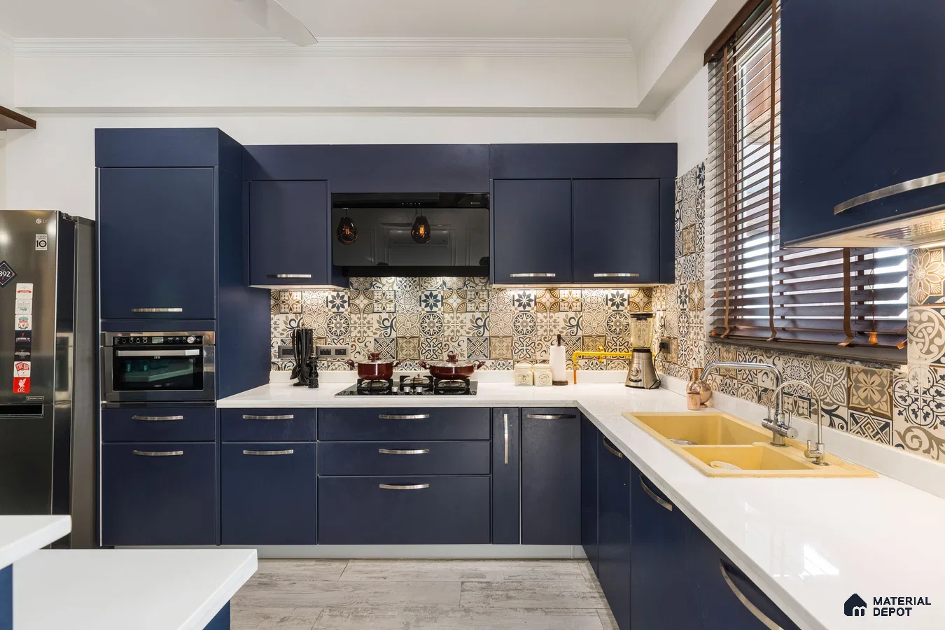 Modern kitchen with navy blue laminate cabinets, white quartz countertop, and patterned moroccan backsplash tiles in Bengaluru | Material Depot