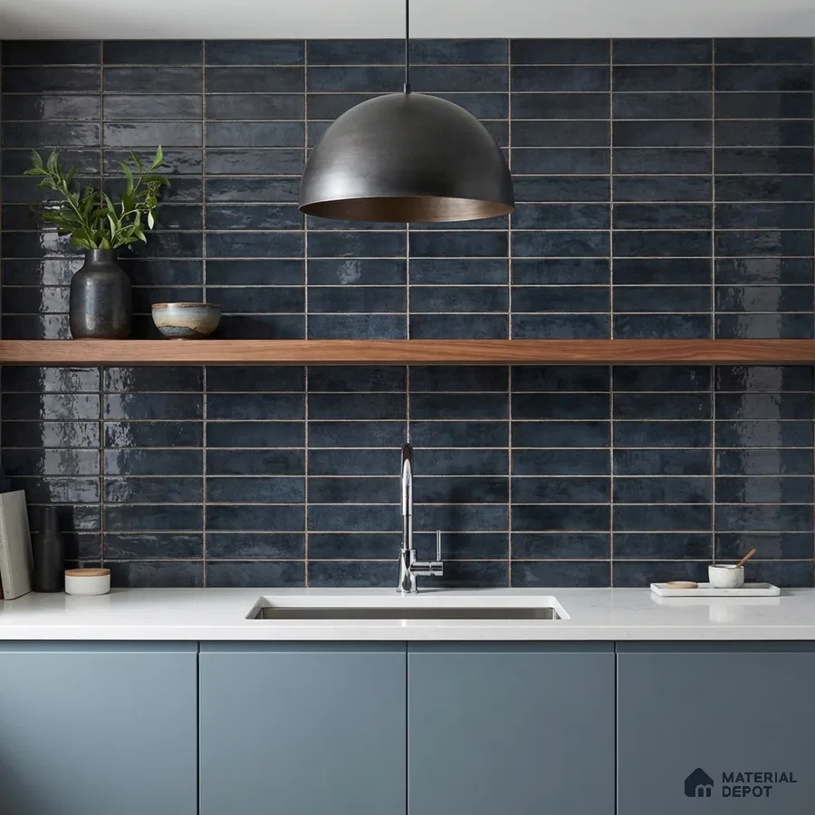 Modern kitchen with navy blue subway wall tiles, matte blue laminate cabinets, and white quartz countertop