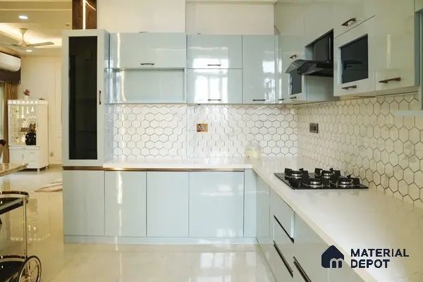 Modern kitchen with pastel blue high gloss laminate, white quartz countertop, and white hexagonal backsplash tile in Bengaluru | Material Depot