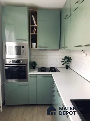 Modern kitchen with pastel green high gloss laminate cabinets, white quartz countertop, and white subway tile backsplash in Bengaluru | Material Depot