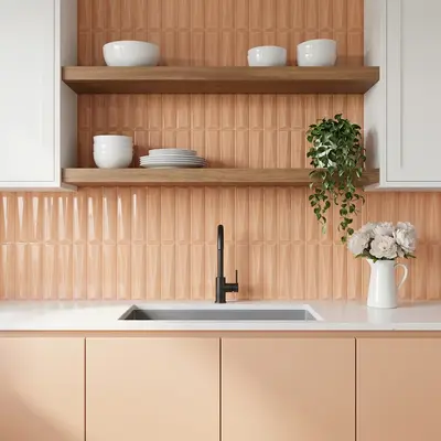 Modern kitchen with peach geometric wall tiles, white quartz countertop, and pastel peach laminate cabinets