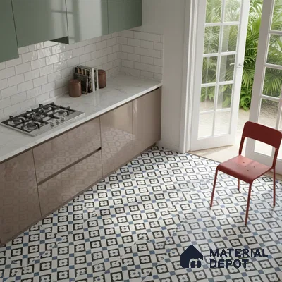 Modern kitchen with sage green and taupe laminate, white marble countertop, and blue geometric patterned floor tiles in Bengaluru
