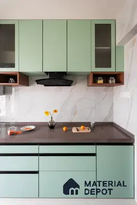 Modern kitchen with sage green laminate cabinets, brown quartz countertop, and marble-look wall tiles in Bengaluru | Material Depot