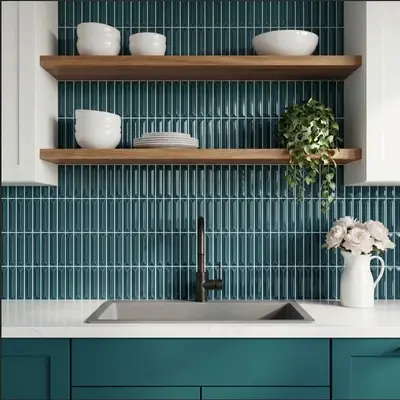 Modern kitchen with teal kitkat backsplash tile, white quartz countertop, and teal laminate cabinets