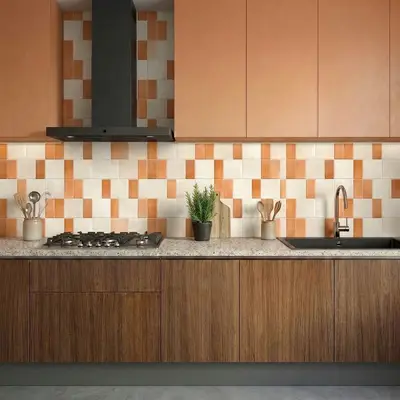 Modern kitchen with terracotta and beige patterned backsplash tile, peach laminate, and wood grain laminate base cabinets