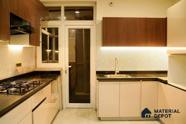 Modern kitchen with walnut wood laminate, beige high gloss laminate, black granite countertop, and geometric backsplash tiles in Bengaluru | Material Depot