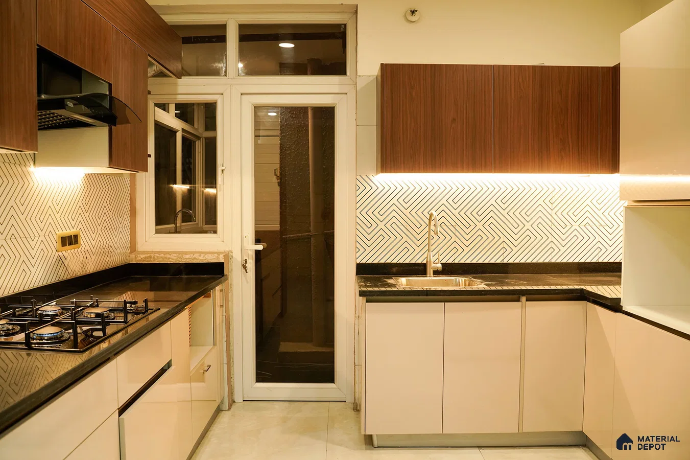 Modern kitchen with walnut wood laminate, beige high gloss laminate, black granite countertop, and geometric backsplash tiles in Bengaluru | Material Depot