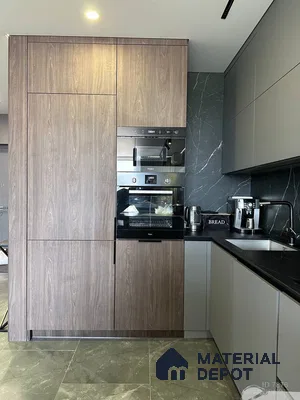 Modern kitchen with walnut wood laminate, matte grey laminate, and black marble backsplash in Bengaluru | Material Depot
