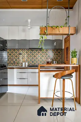 Modern kitchen with white and grey laminate cabinets, geometric patterned backsplash tile, and wooden accents in Sattva Anugraha Vijayanagar 3 BHK Bengaluru Apartment