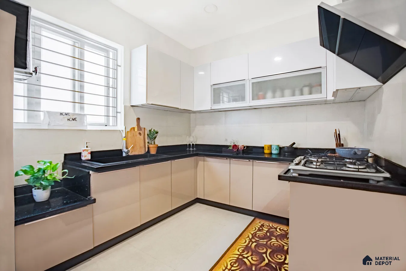 Modern L-shaped kitchen with beige and white high gloss laminate cabinets and black granite countertop in Bengaluru | Material Depot
