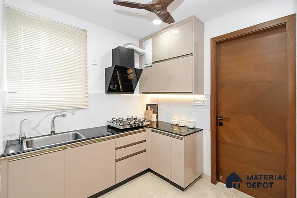 Modern L-shaped kitchen with beige high gloss laminate cabinets and black granite countertop in Bengaluru | Material Depot