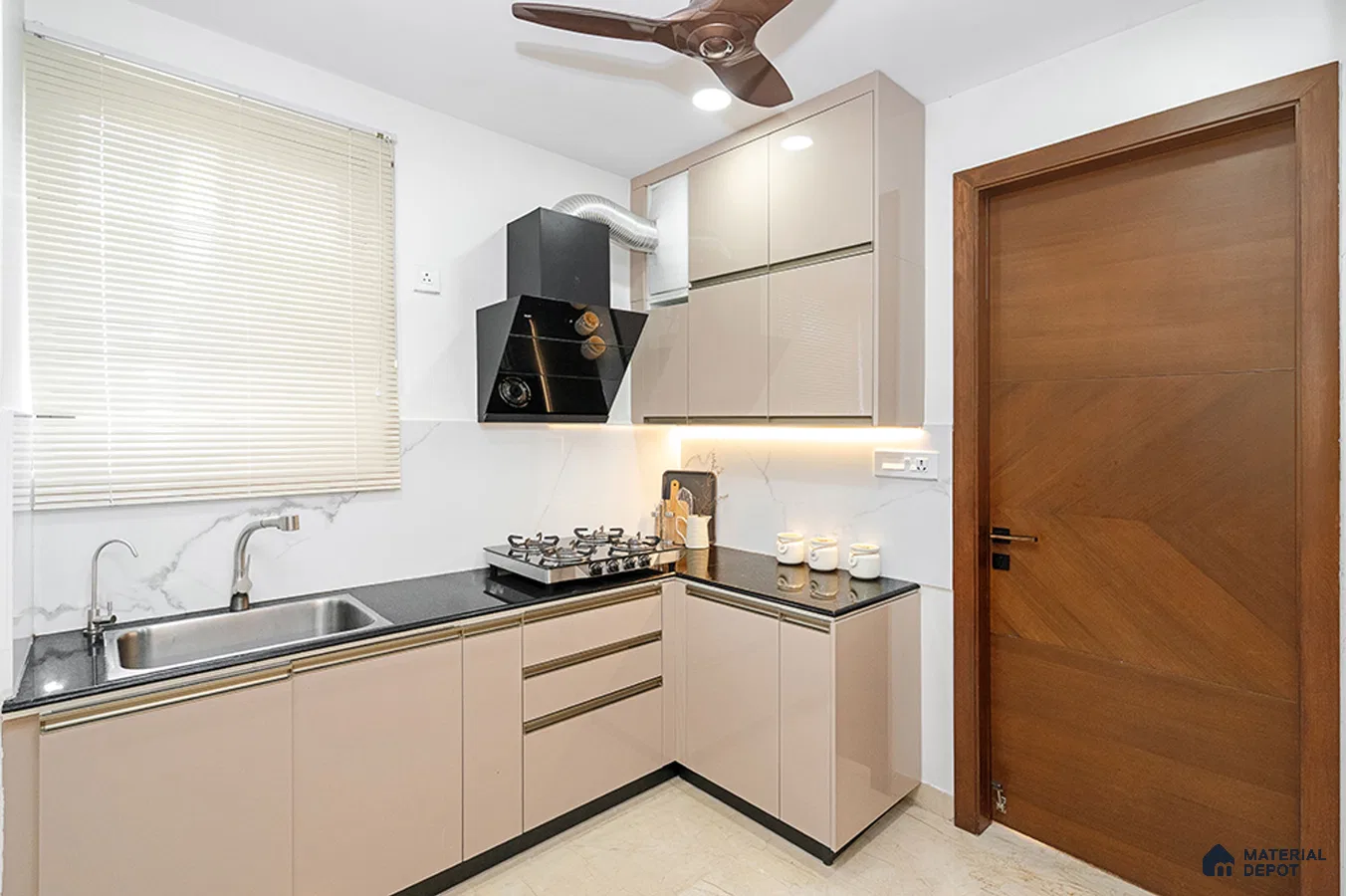 Modern L-shaped kitchen with beige high gloss laminate cabinets and black granite countertop in Bengaluru | Material Depot