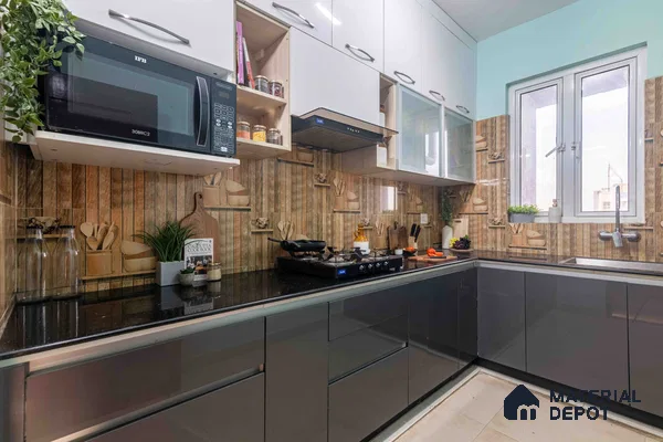 Modern L-shaped kitchen with glossy grey and frosty white laminate, black granite countertop, and wood-look patterned backsplash tile in Bengaluru | Material Depot