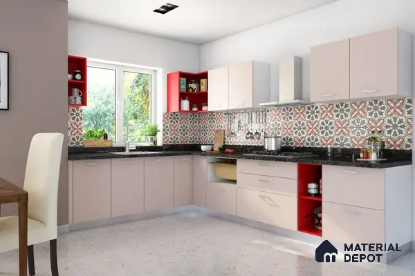 Modern L-shaped kitchen with pastel pink laminate, red open shelves, black granite countertop, and patterned moroccan backsplash tiles in Bengaluru | Material Depot