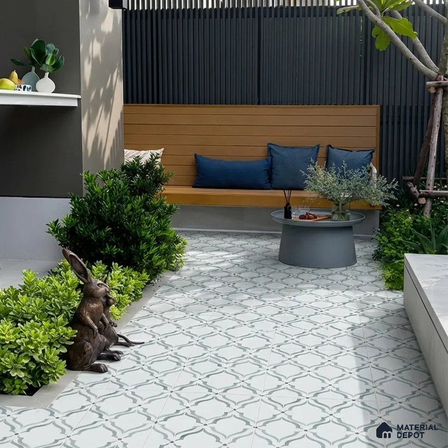 Modern outdoor seating with patterned floor tiles and wooden bench