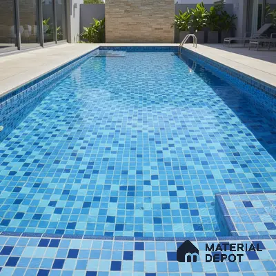 Modern outdoor swimming pool with blue mosaic tiles and stone cladding accent wall