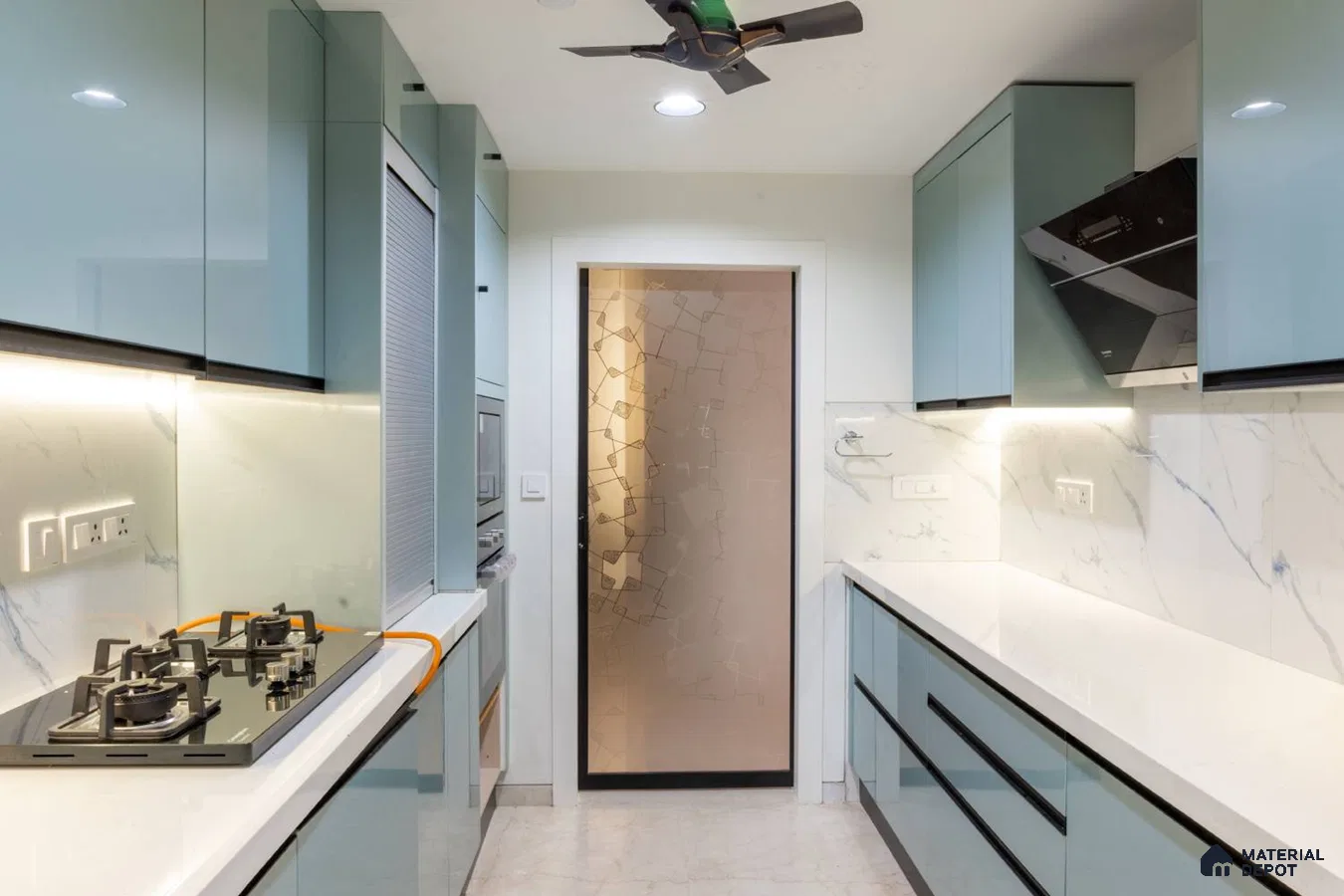 Modern parallel kitchen with pastel blue high gloss laminate, white quartz countertop, and marble-look backsplash in Bengaluru | Material Depot