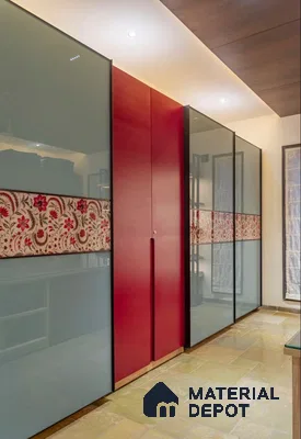 Modern wardrobe with frosty blue glass shutters, red solid color laminate, and floral patterned panel | Material Depot